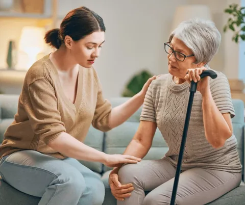 Home caregiver providing companionship and support to an older woman